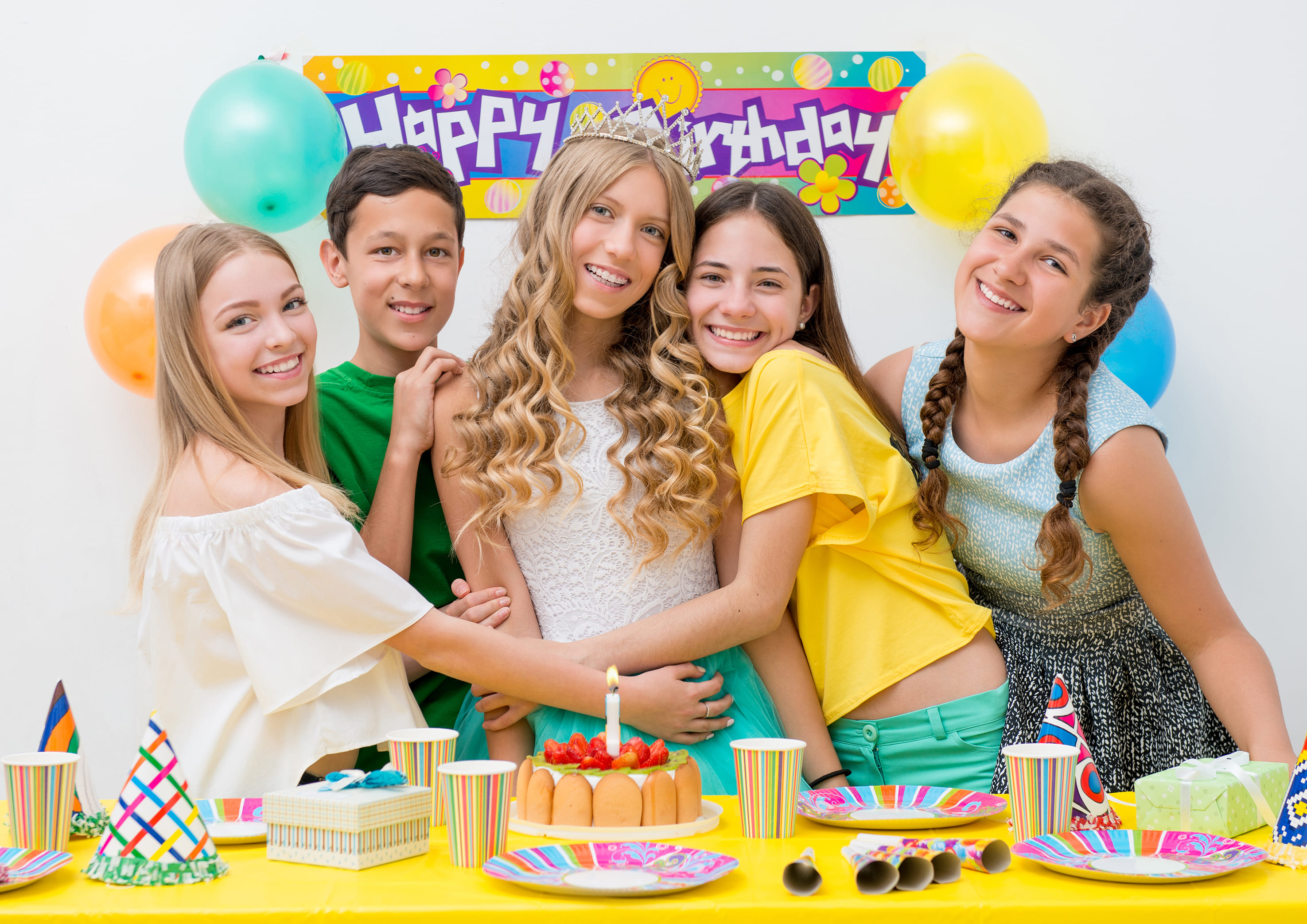 Happy teens celebrating a birthday together