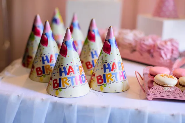 Happy Birthday party hats on a dessert table